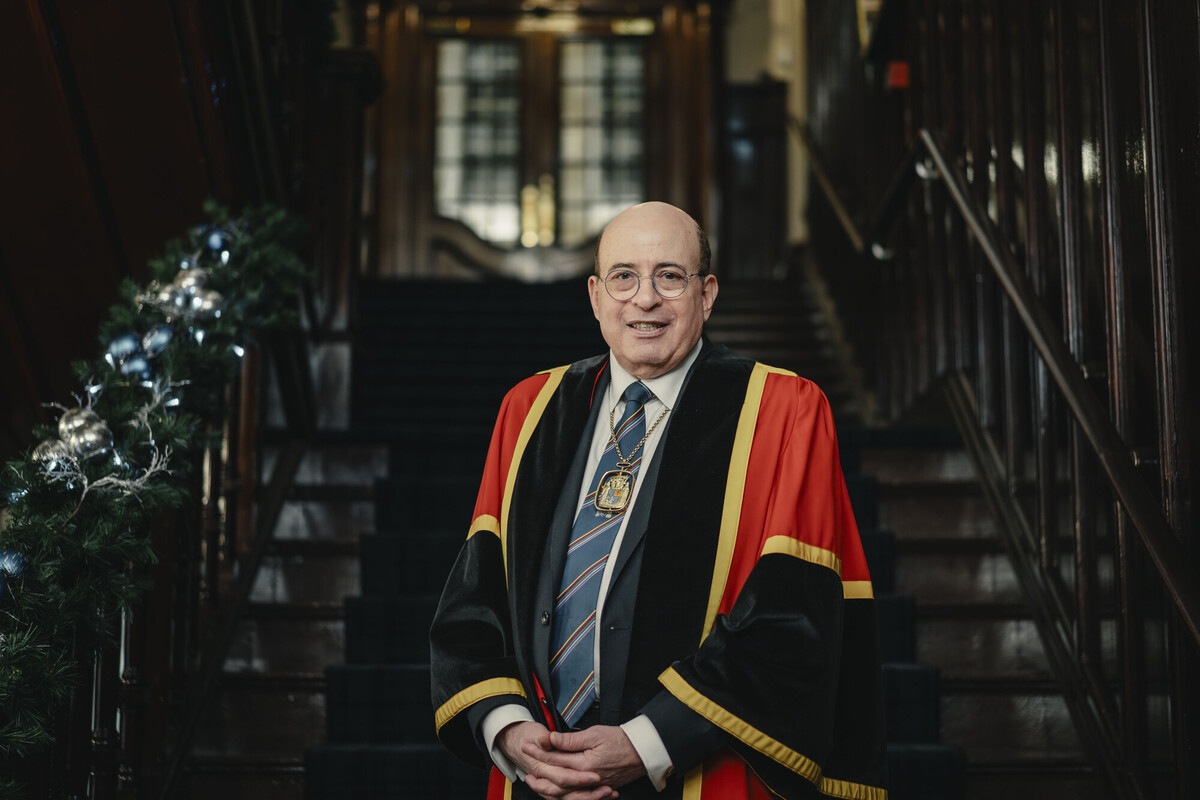 President Professor Hany Eteiba, standing in the College entrance way which is decorated for Christmas